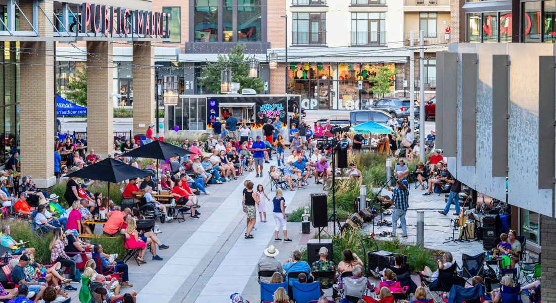 Lenexa, KS Public Market outdoor concert with large crowd of people enjoying the music